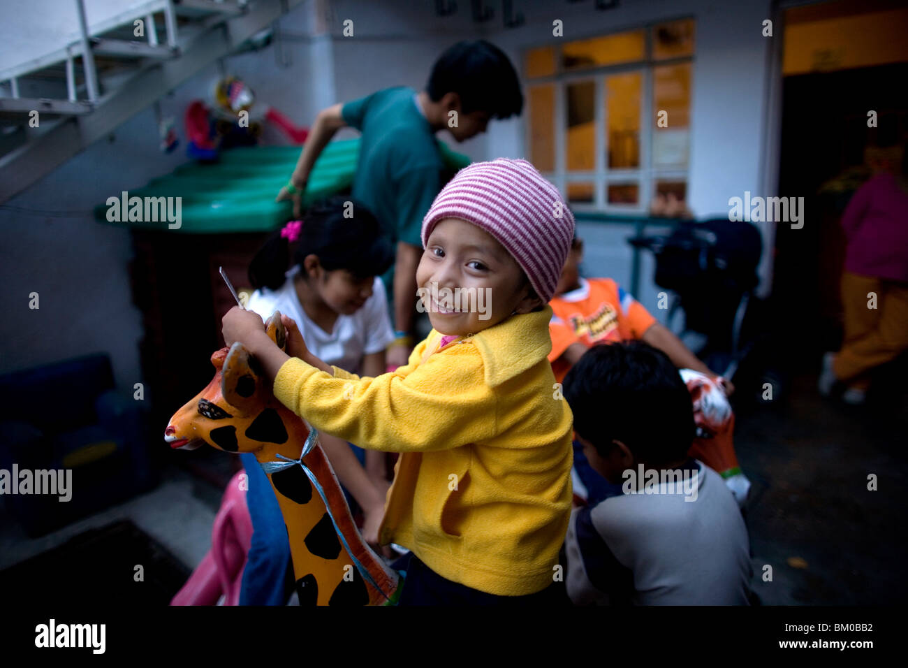 Cecilia Hipolito Lucas, who suffers cancer of the eye, plays in a shelter for chronically ill children in Mexico City Stock Photo