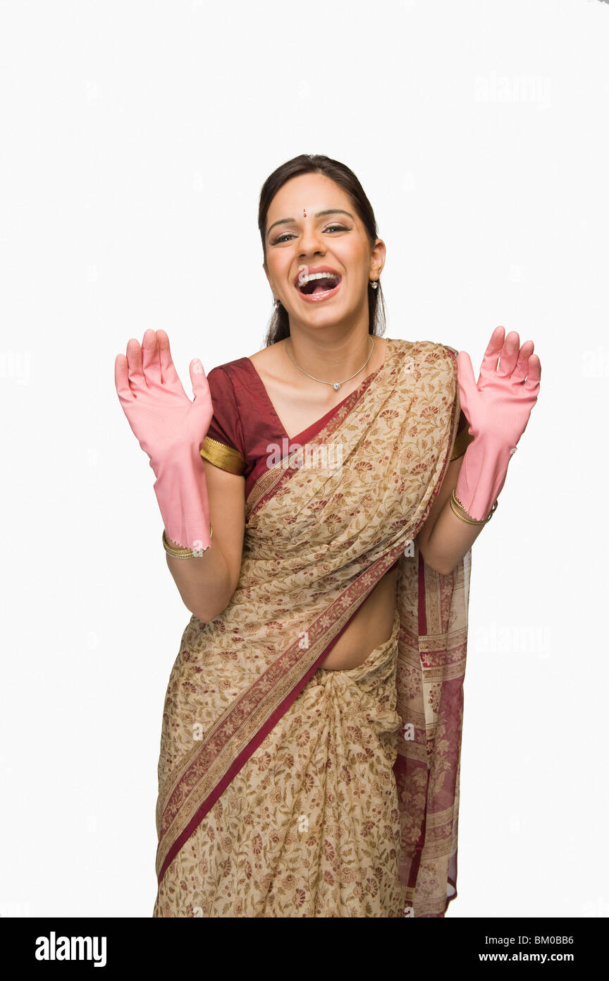 Woman wearing washing up gloves and laughing Stock Photo Alamy