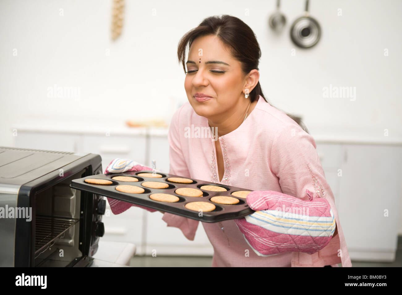 Woman smelling baked cookies hires stock photography and images Alamy