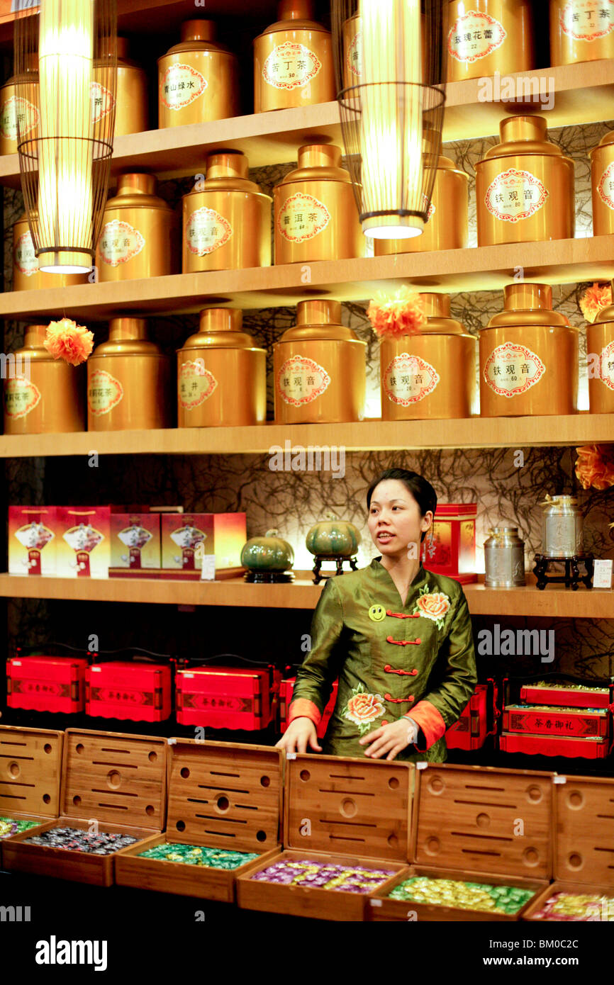 Young saleswoman at a tea shop, Xiamen, Fujian province, China, Asia Stock Photo