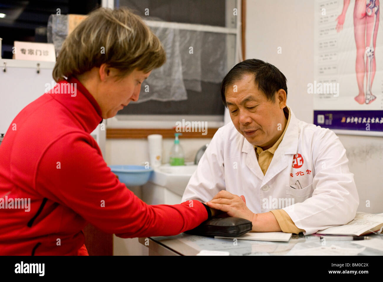 Chinese doctor examining german patient, Xiamen, Fujian, China, Asia Stock Photo