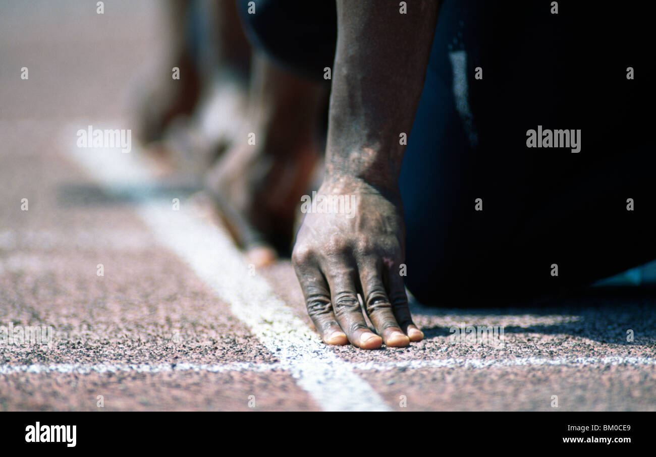 Man crouching on starting block hi-res stock photography and images - Alamy