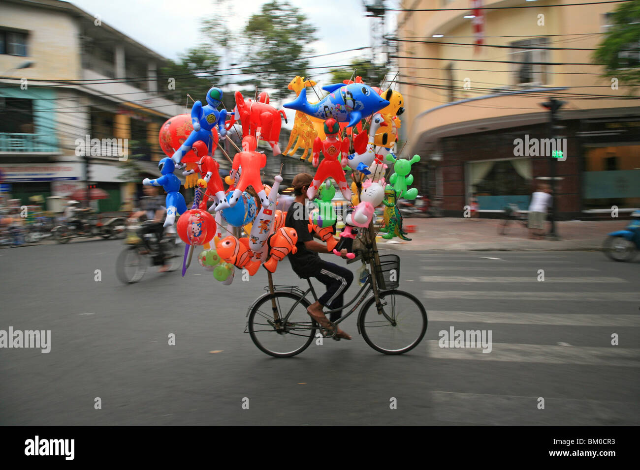 Balloon vendor on a bike during Tet festival, Saigon, Ho Chi Minh City