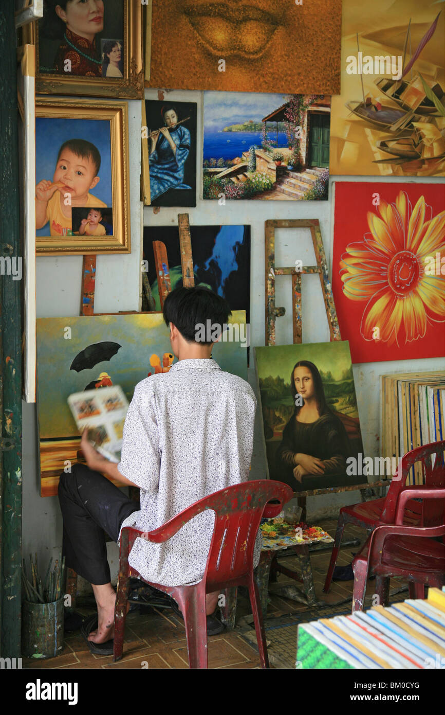 Man and reproductions of famous paintings in a shop, Saigon, Ho Chi Minh City, Vietnam, Asia Stock Photo
