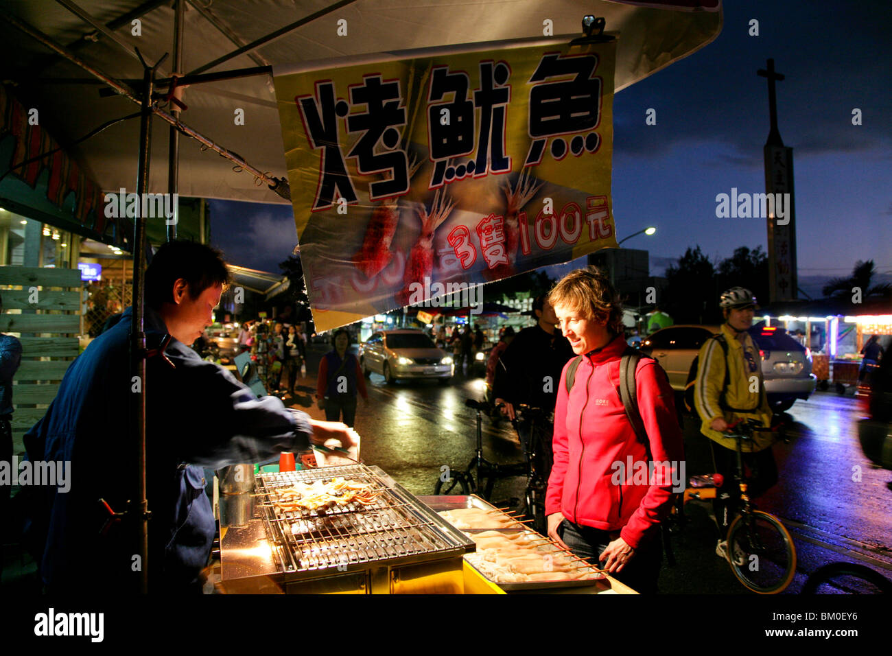 Tourist buying grilled octopus at the night market, Kenting National Park, Kenting, Kending, Republic of China, Taiwan, Asia Stock Photo