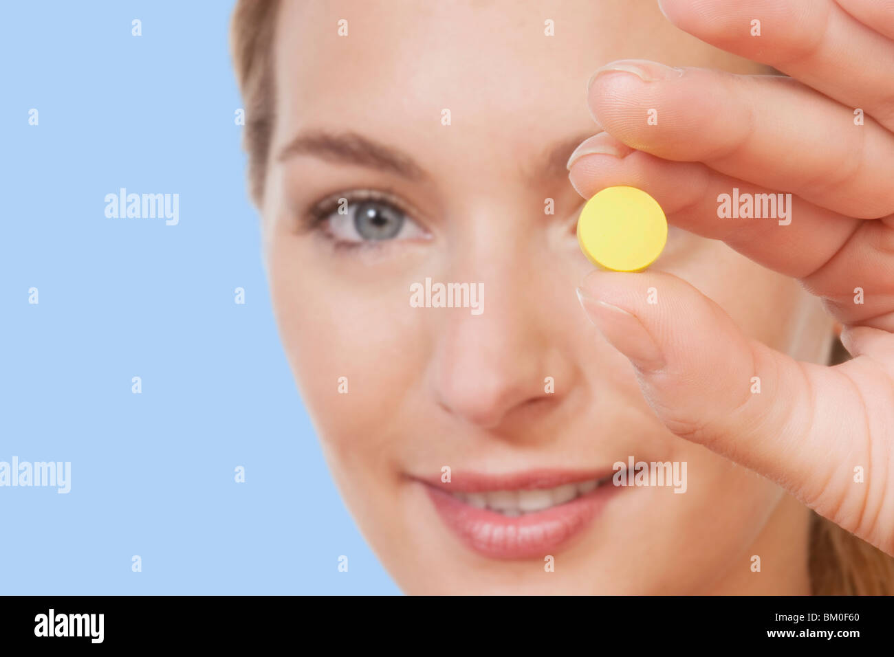 Woman showing a pill Stock Photo