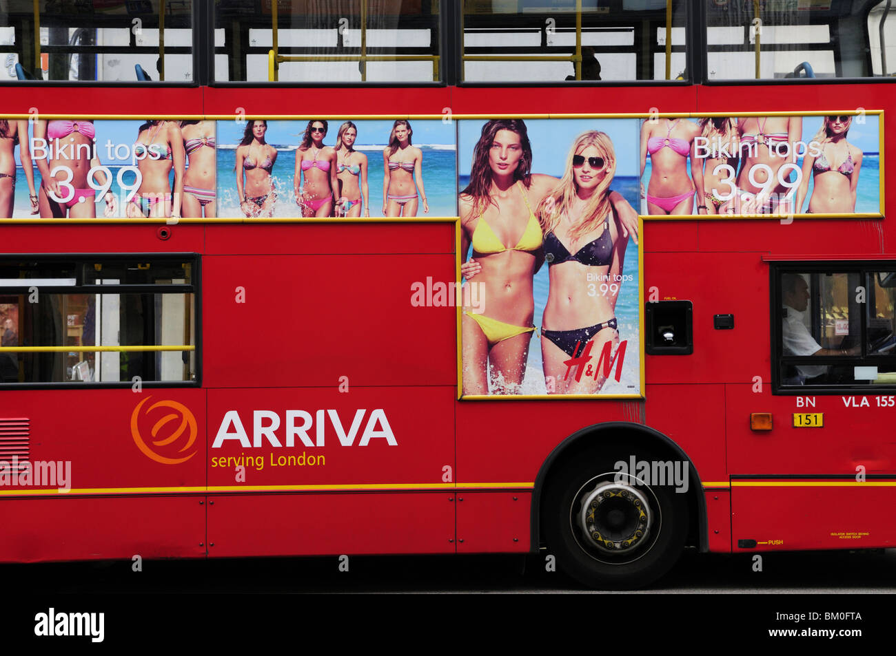 Arriva red London bus with H&M bikini advertisement, Oxford Street, London, England, UK Stock Photo