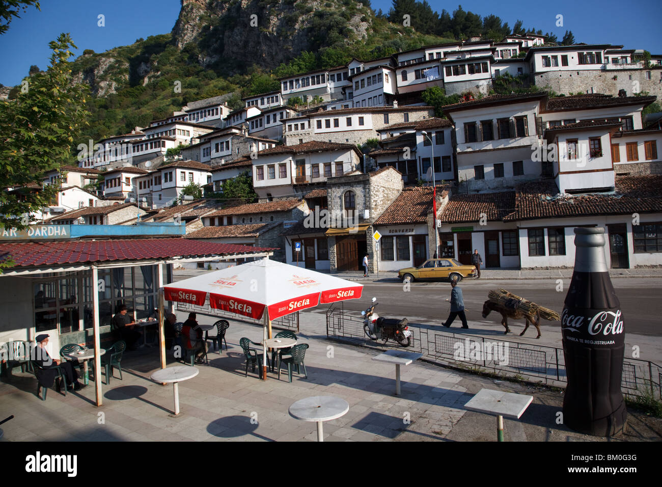 A local cafe on a large Coca Cola advert in Berat, Albania. Stock Photo