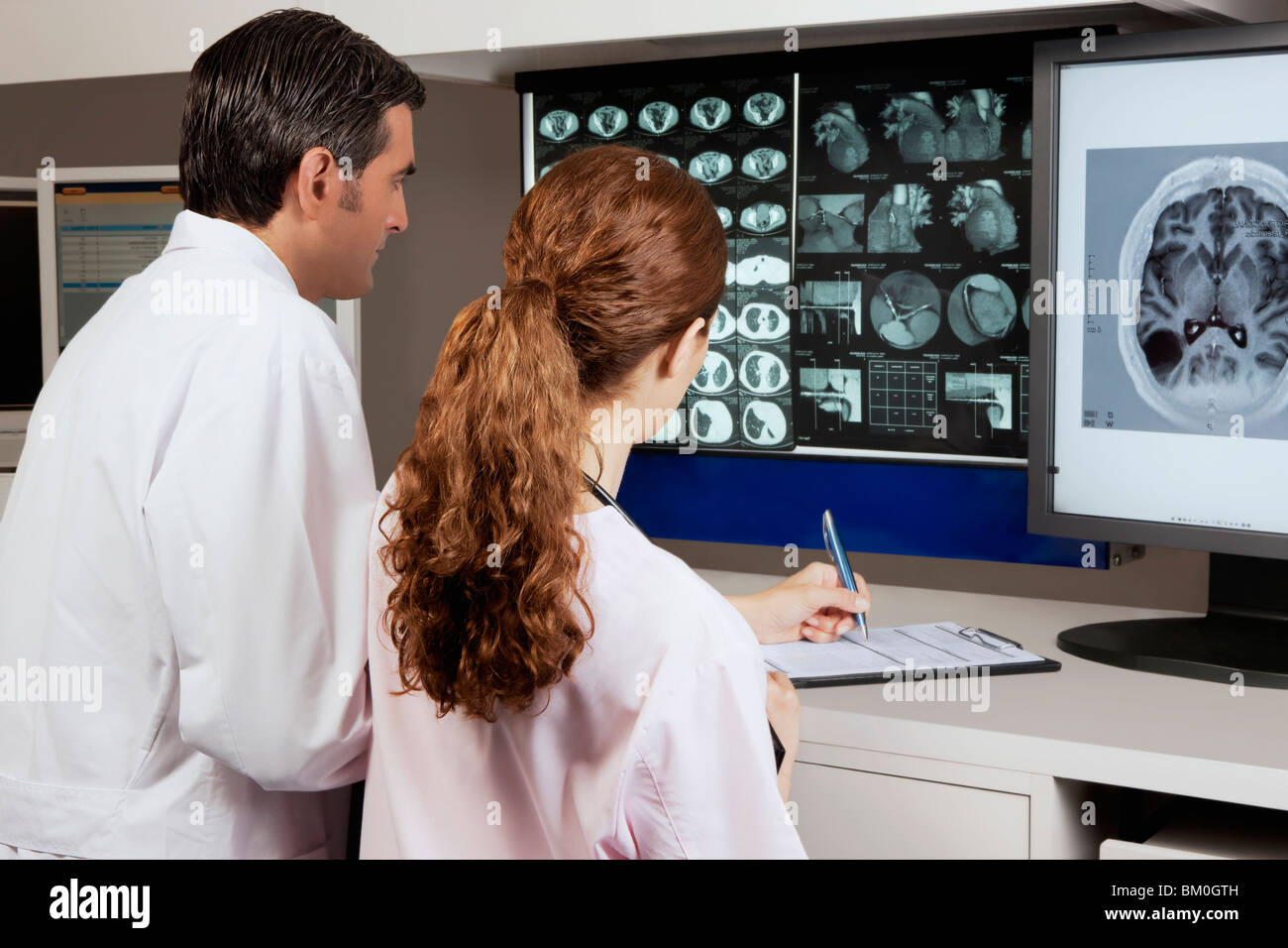 Two doctors examining MRI report Stock Photo