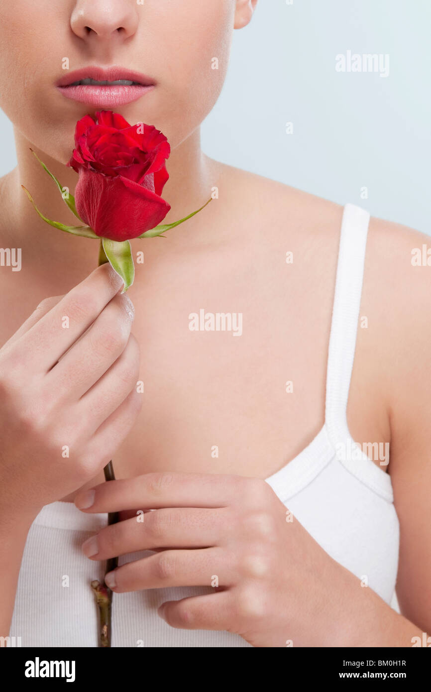 Close-up of a woman smelling a rose Stock Photo - Alamy