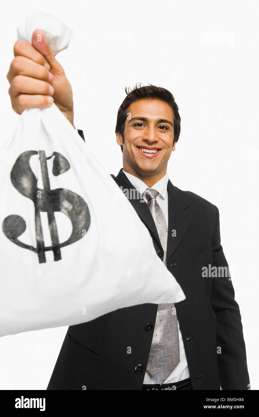 Portrait of a businessman holding a money bag Stock Photo Alamy