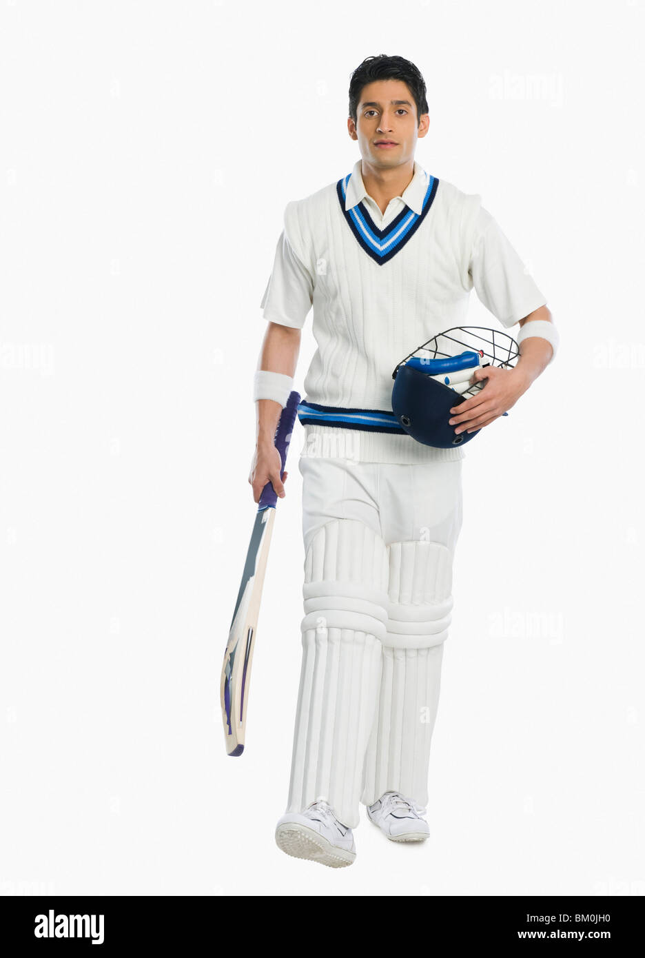 Carring Bat Cricket batsman carrying a bat and a helmet Stock Photo - Alamy