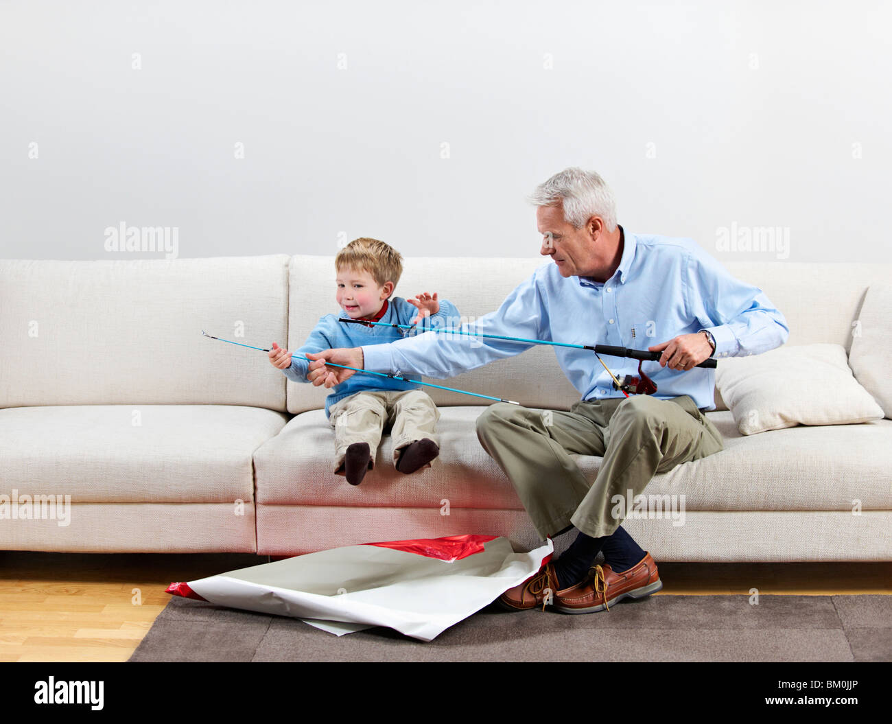 Boy and grandfather with new fishing rod Stock Photo