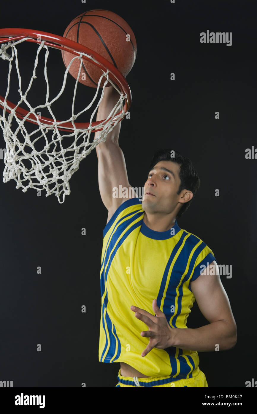 Basketball player dunking a ball Stock Photo Alamy