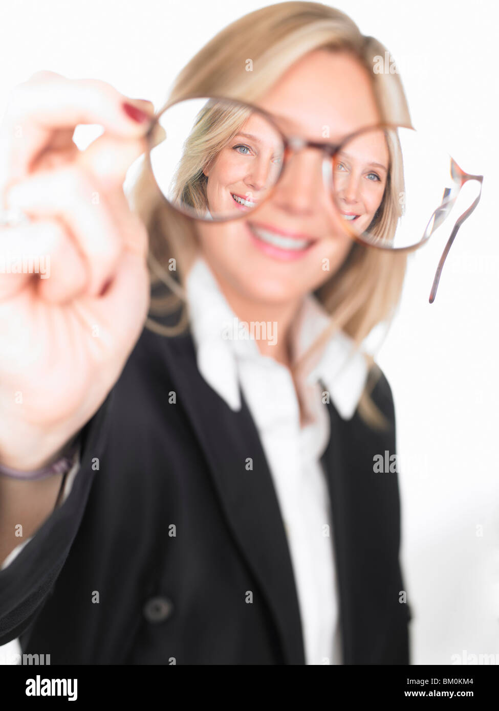 Woman holding glasses in front of her Stock Photo Alamy