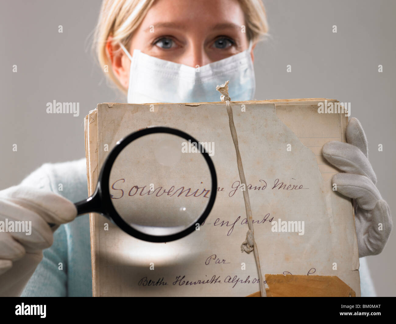 Woman with magnifying glass showing file Stock Photo