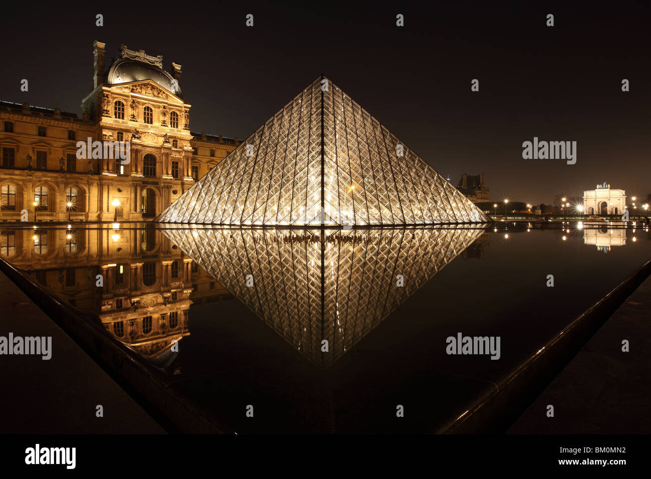 Louvre Pyramid in Paris France by I.M. Pei, photograph taken at night Stock Photo