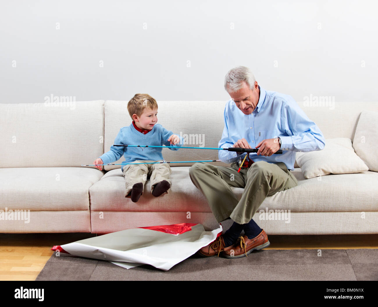 Boy and grandfather with new fishing rod Stock Photo