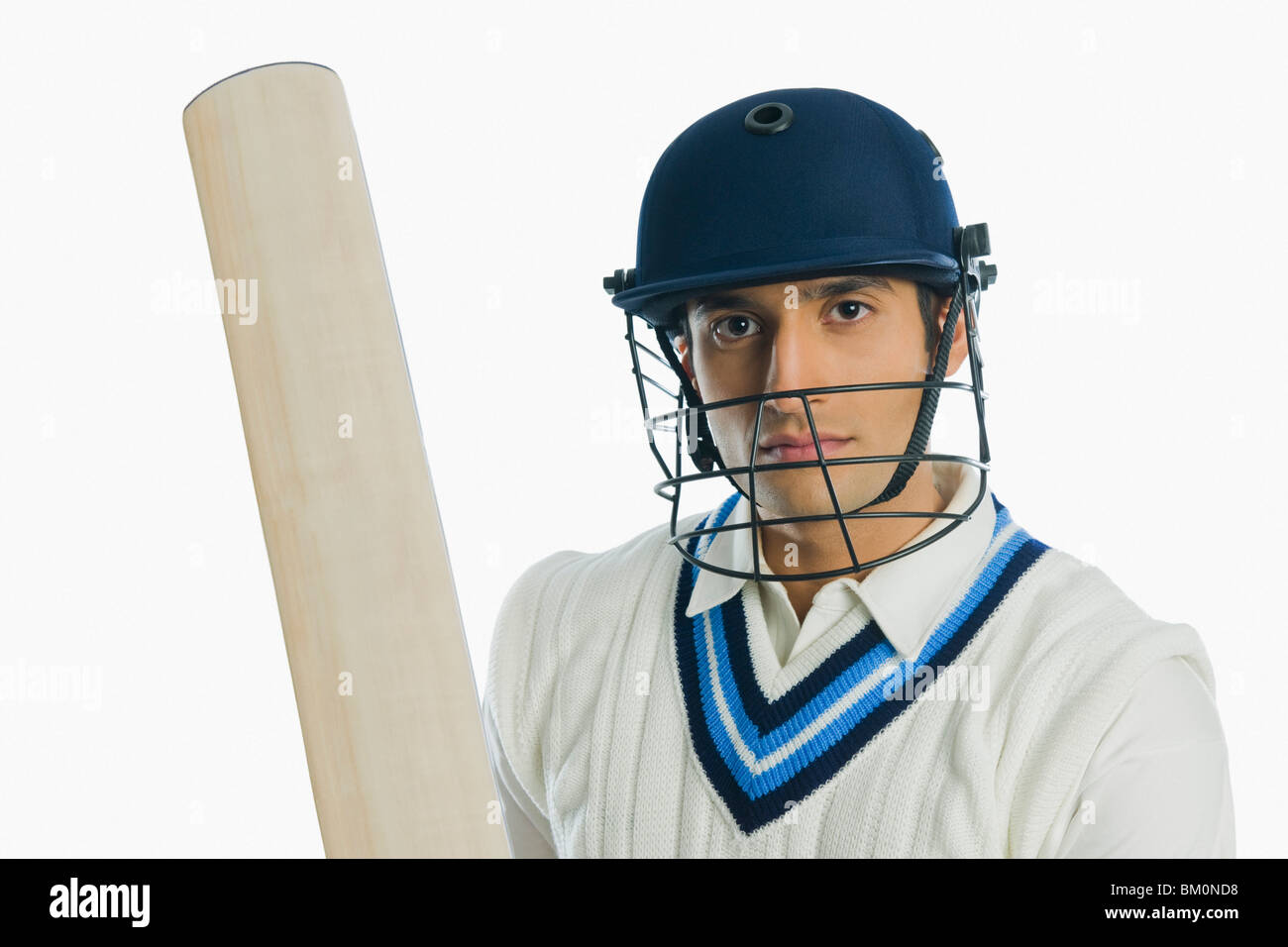 Portrait of a cricket batsman holding a bat Stock Photo Alamy