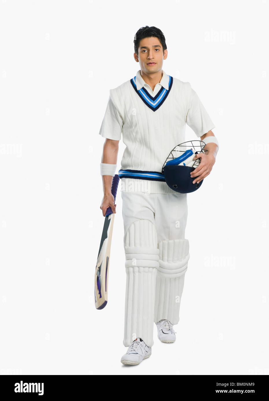Cricket batsman carrying a bat and a helmet Stock Photo Alamy