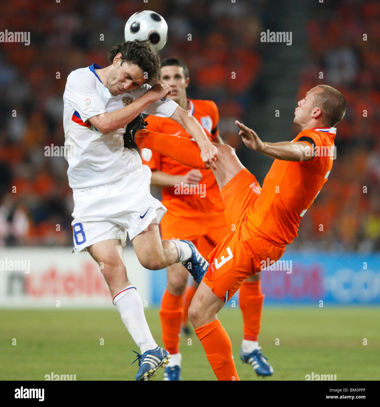 Denis Kolodin of Russia (8) and John Heitinga of the Netherlands (3) via for the ball during a UEFA Euro 2008 match June 21 2008 Stock Photo