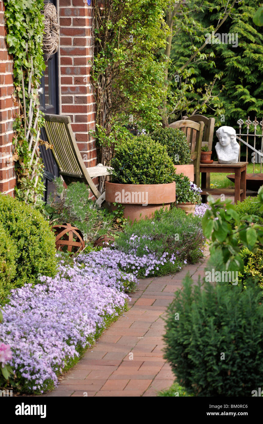 Front garden with seating area and flower tubs Stock Photo