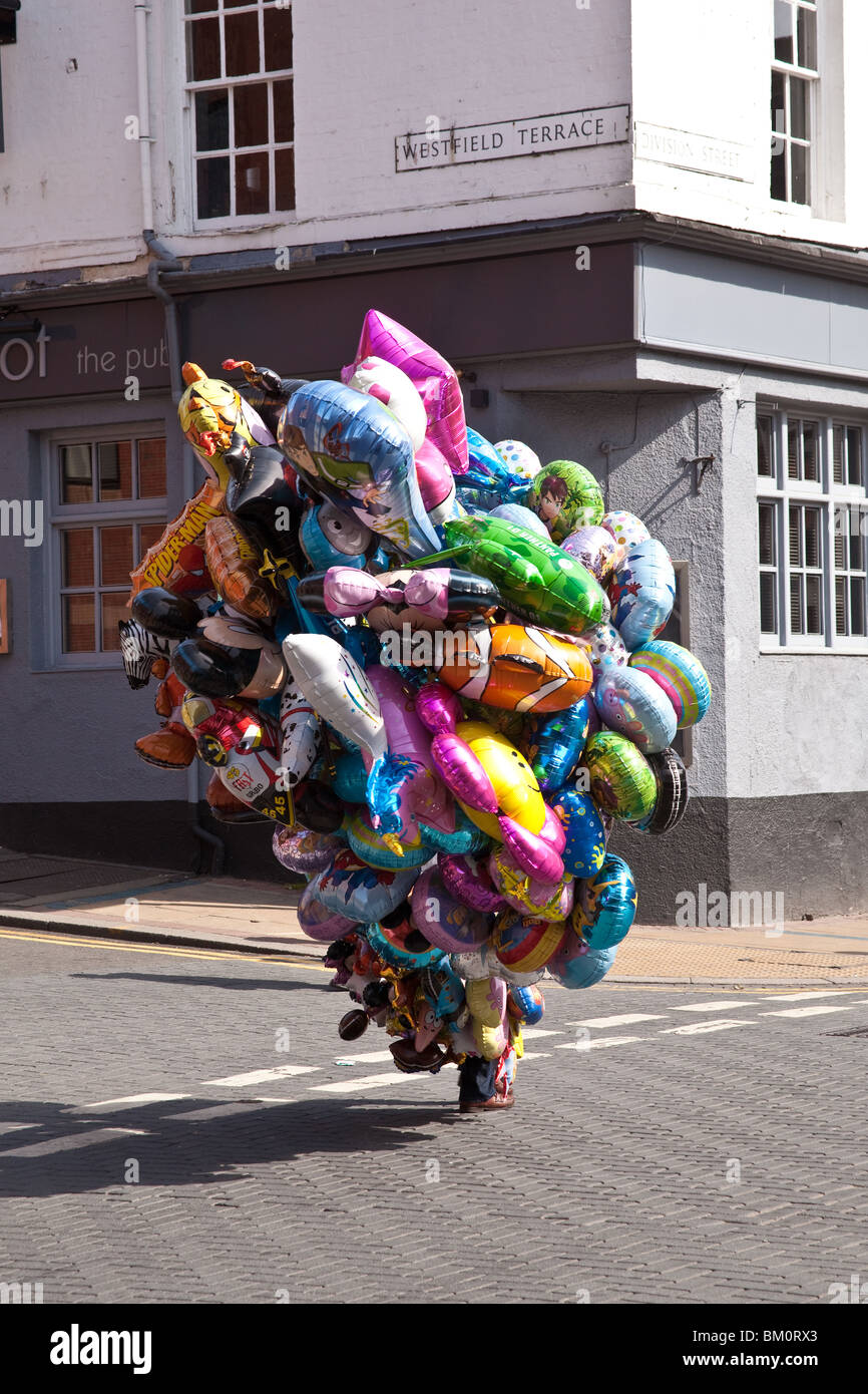 Street vendor with a huge bunch of helium foil balloons , Sheffield, England. Stock Photo