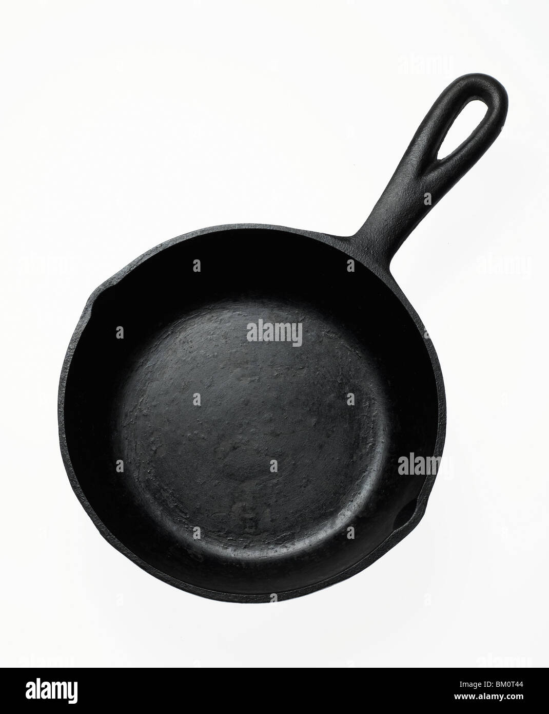 black cast iron fry pan on white background Stock Photo
