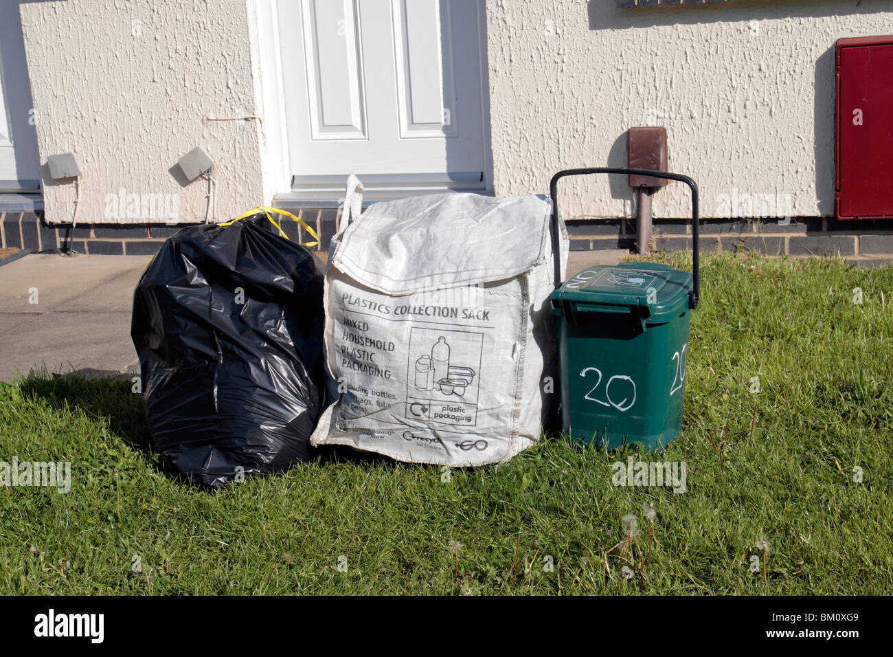 Normal waste black bag, plastics collection container and food waste  container outside residence in Hounslow, Middx, UK Stock Photo - Alamy