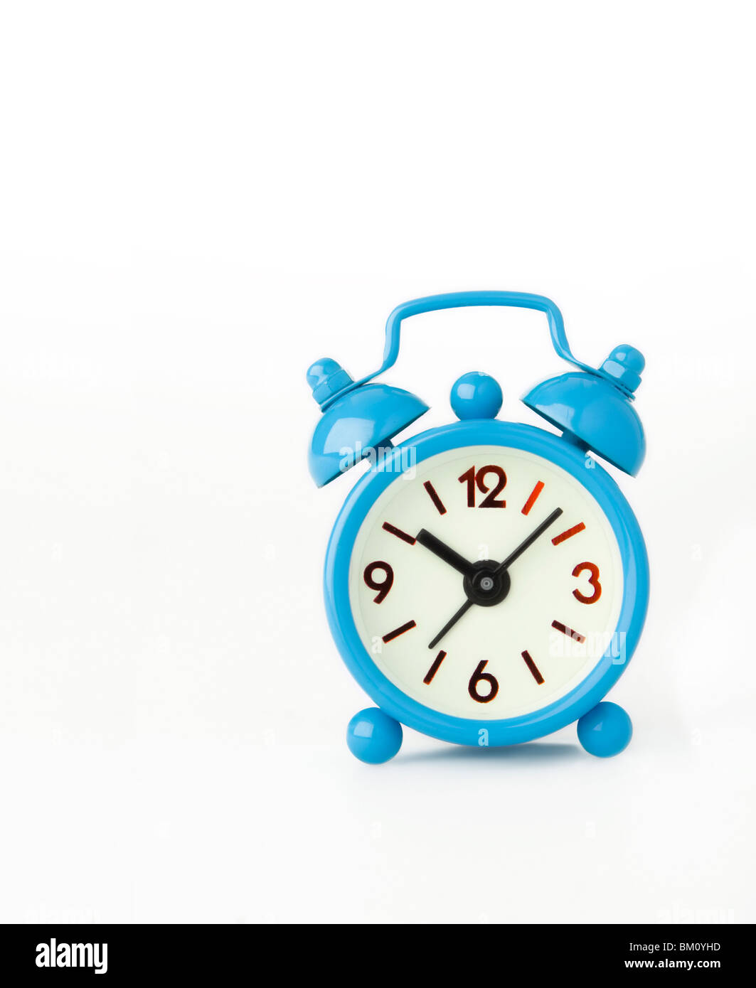 small blue alarm clock isolated in studio Stock Photo Alamy