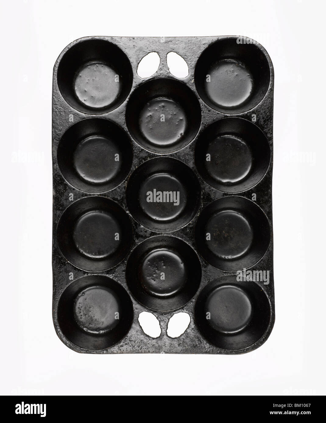 black cast iron muffin pan on white background Stock Photo