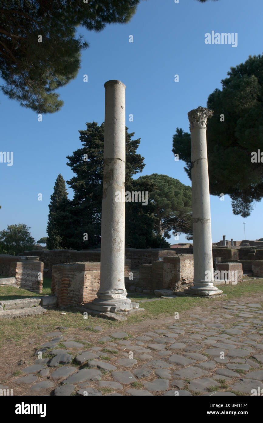 Ostia Antica, Rome. Two columns along the Decumanus Maximus decorating the entrance of the Macellum (Market) Stock Photo