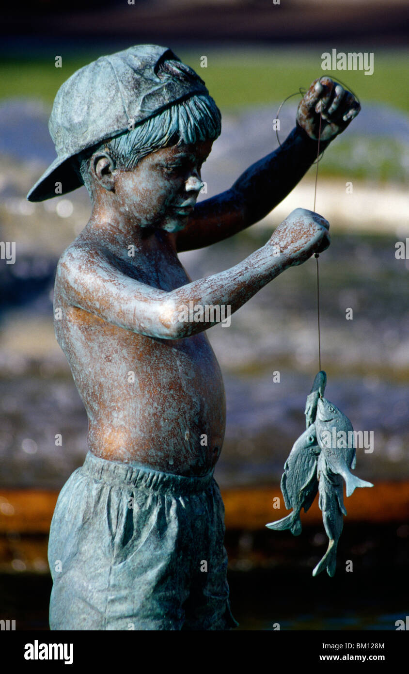 Statue boy holding fish hi-res stock photography and images - Alamy