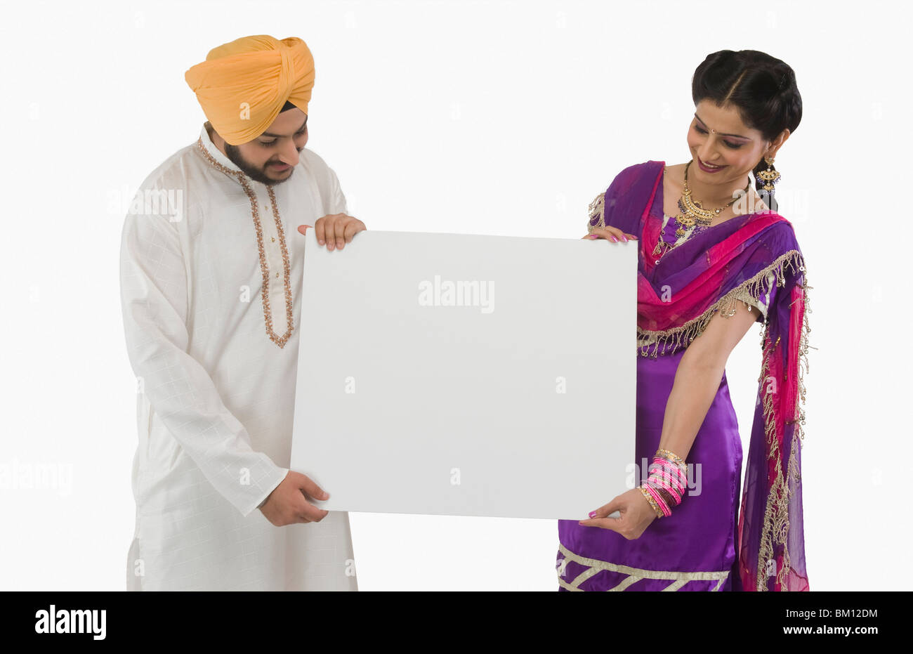 Close-up of a Sikh couple holding a blank placard Stock Photo