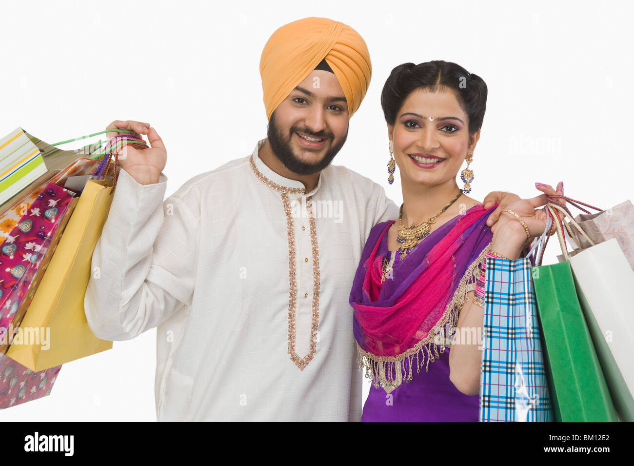 Portrait of a Sikh couple carrying shopping bags Stock Photo