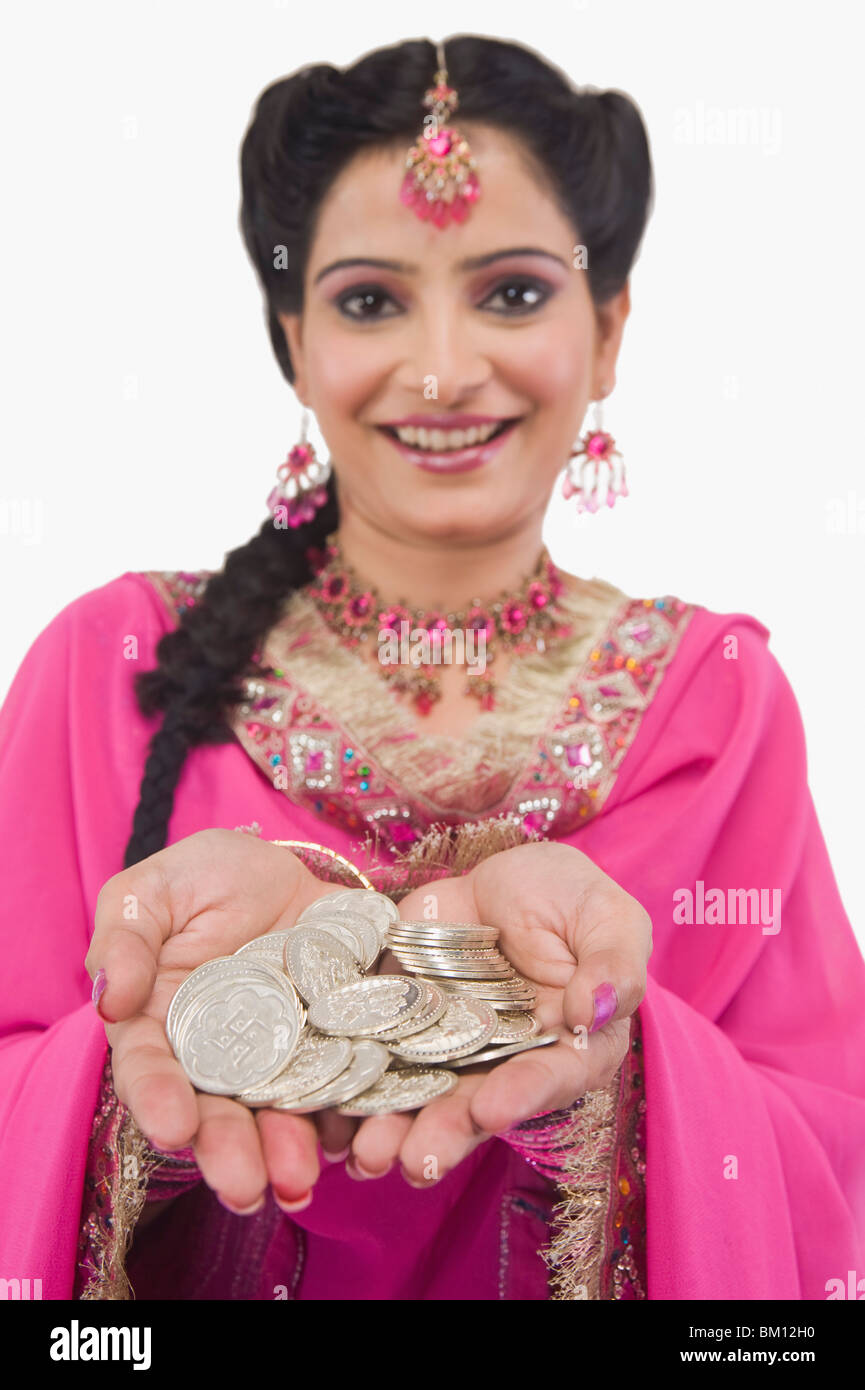 Portrait of a woman holding coins Stock Photo