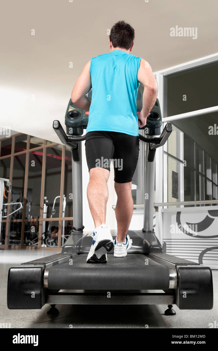 Treadmill Rear View Rear view of a man walking on a treadmill Stock Photo - Alamy