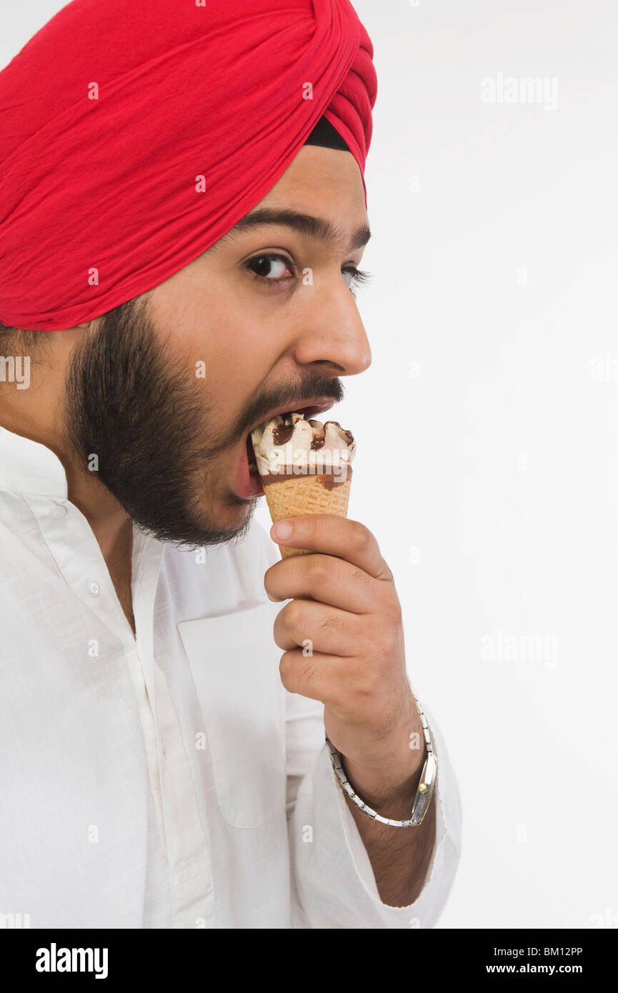 Portrait of a Sikh man eating ice cream Stock Photo