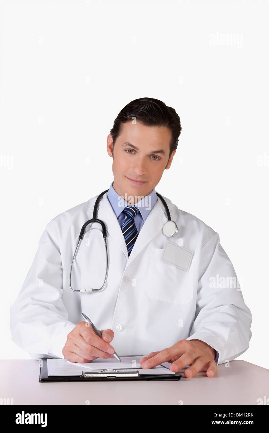 Portrait of a doctor writing on a clipboard Stock Photo