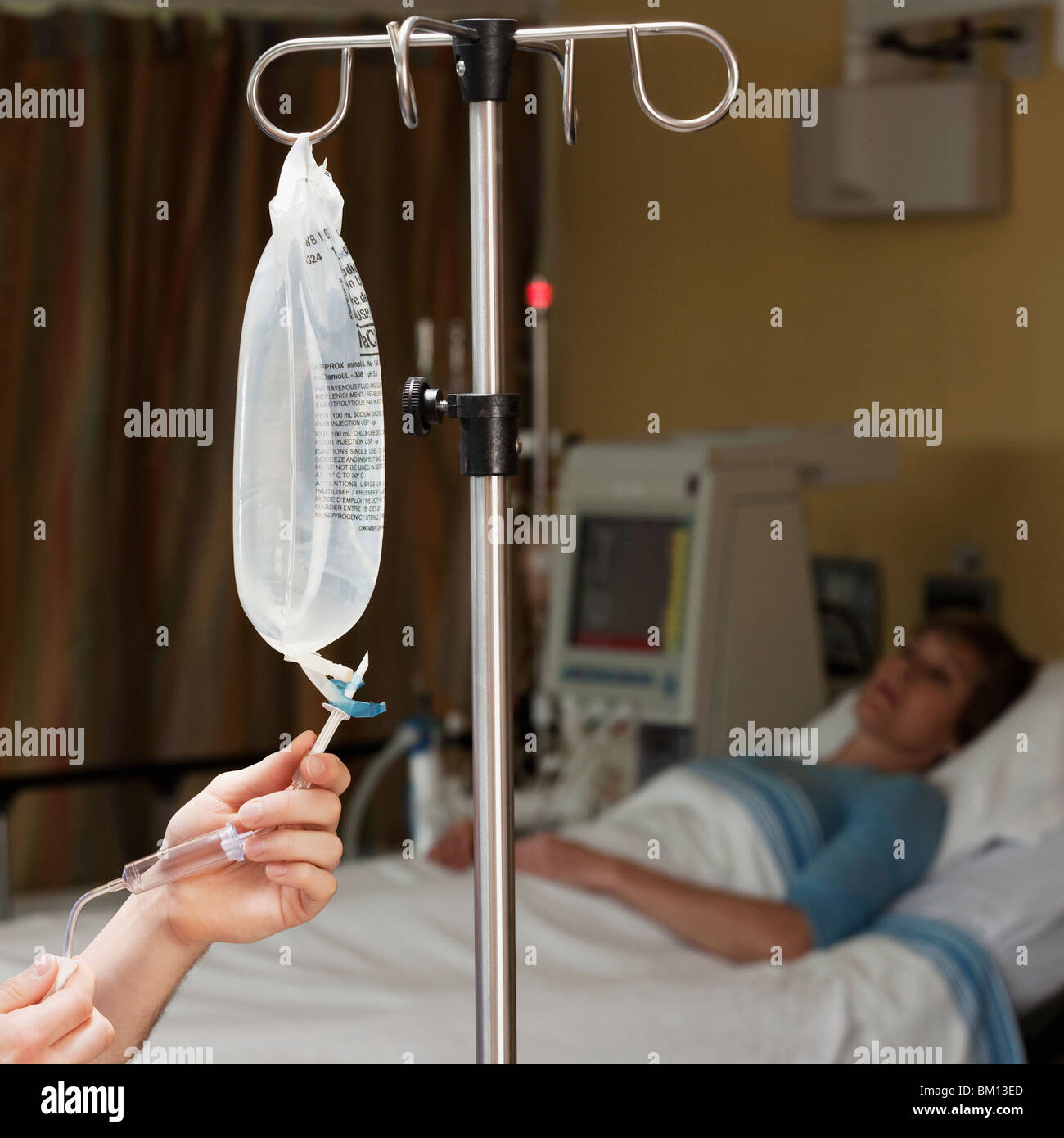 Female doctor checking a saline drip Stock Photo