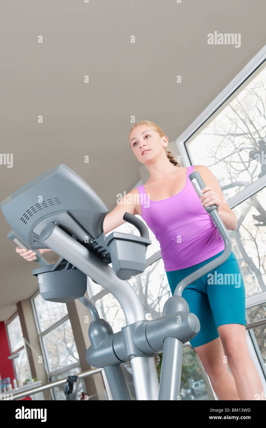 Woman working out on a stepping machine in a gym Stock Photo Alamy
