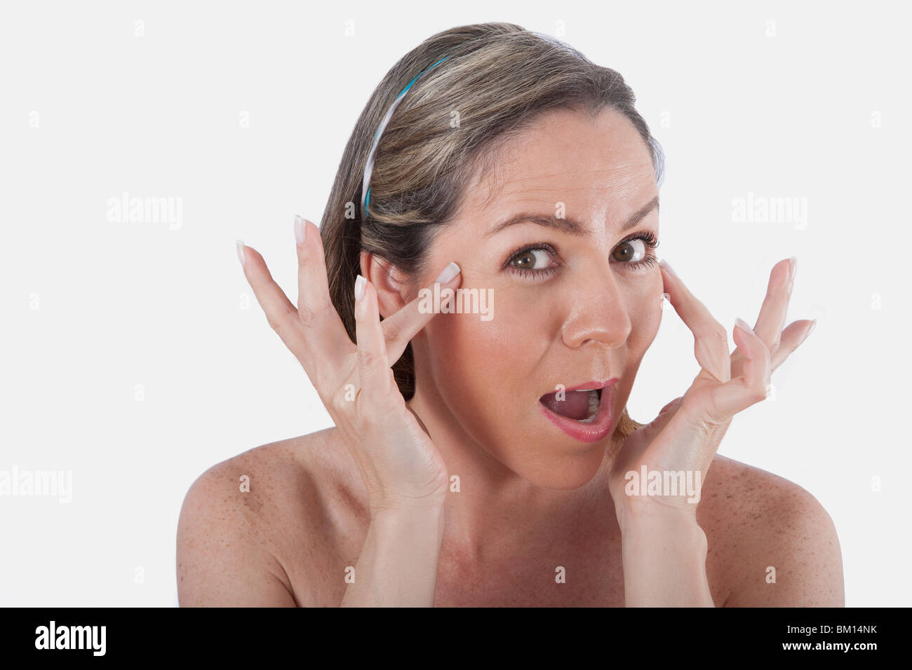 Woman touching her temples Stock Photo