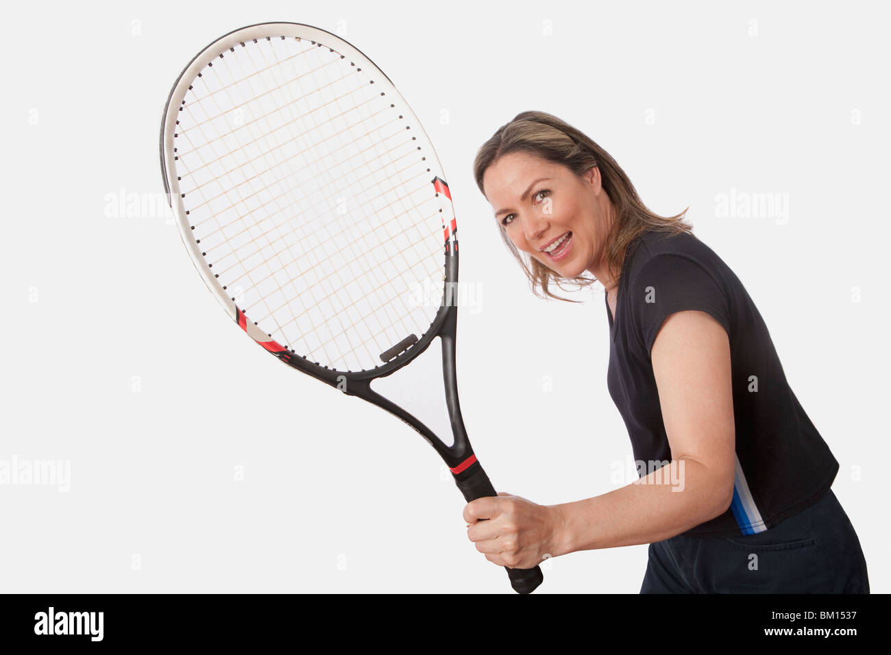 Woman holding a tennis racket and smiling Stock Photo - Alamy