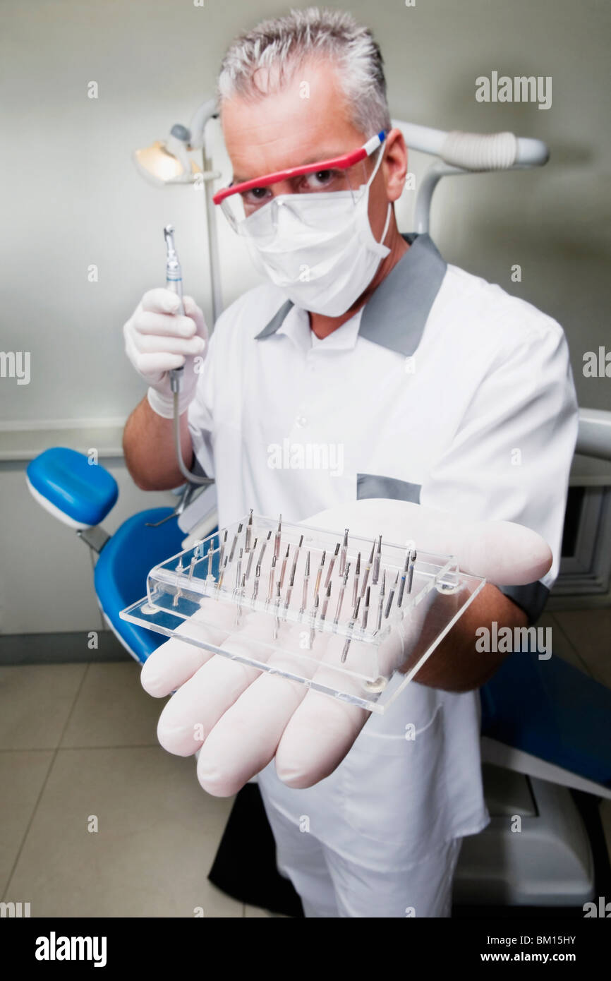 Dentist holding dental drill bits Stock Photo Alamy