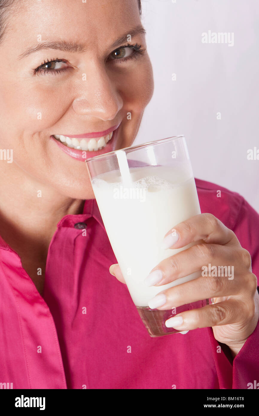 Close-up of a woman drinking milk from a glass Stock Photo