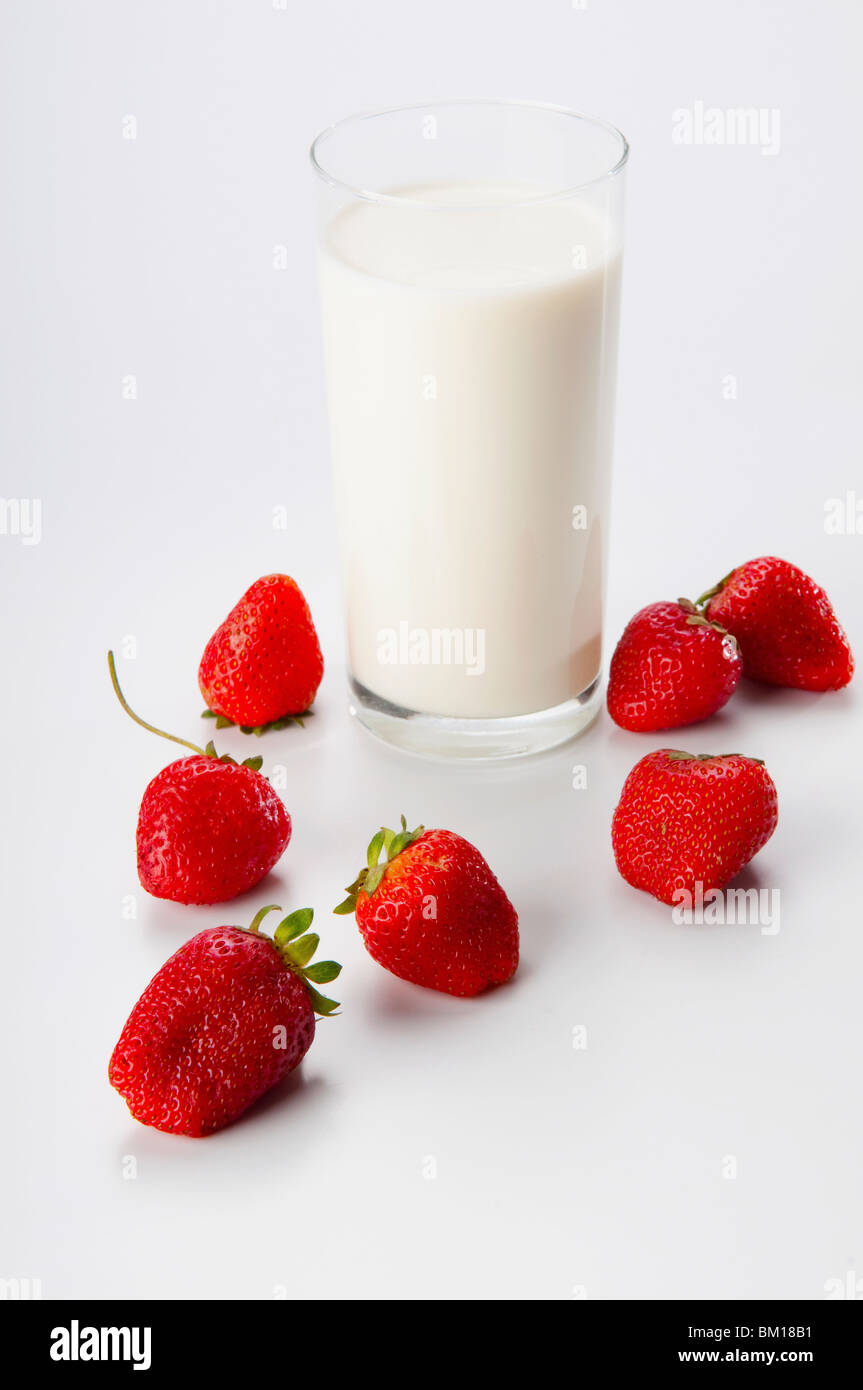 Close-up of a glass of milk and strawberries Stock Photo