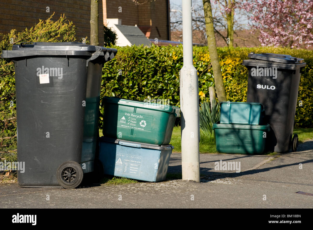 Wheelie bins and recycling boxes waiting for collection on a housing ...