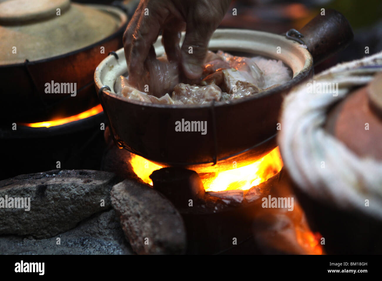 Clay pot cooking chicken on the street near Petaling Street in Kuala
