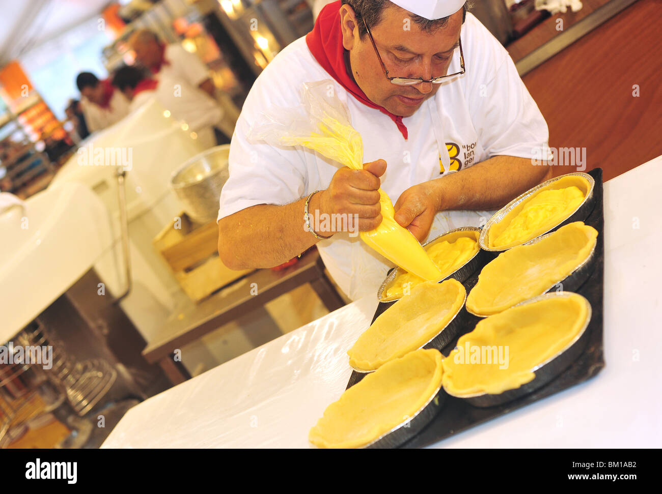 Bakery Warehouse At The Fete Du Pain In Paris Bread Fest Man Squeezing Cream To Prepare A Gateau Basque Basque Cake Stock Photo Alamy