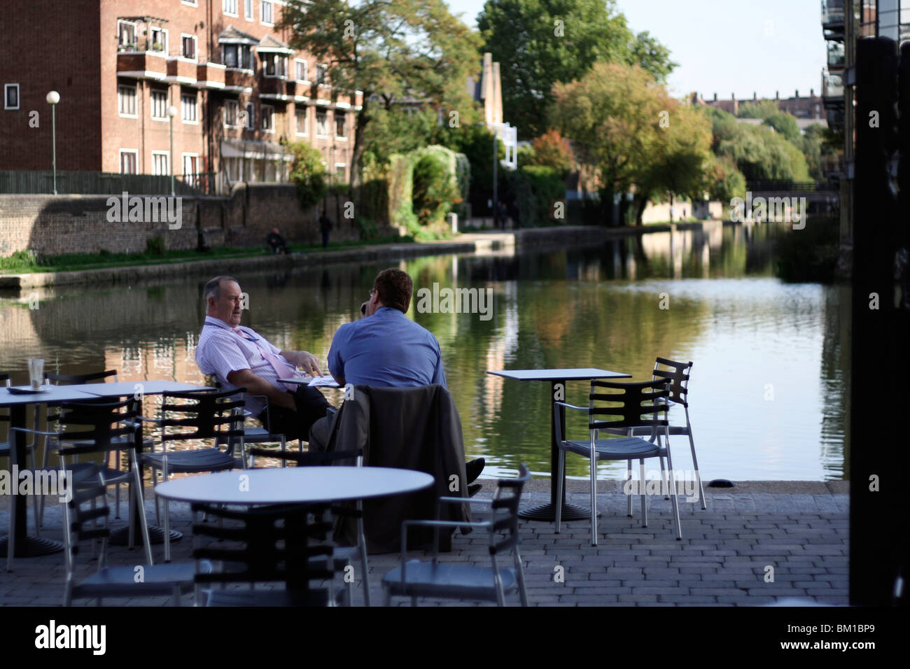 two bussiness men sat having lunch by the river/ canal in london near kings cross and camden. Stock Photo